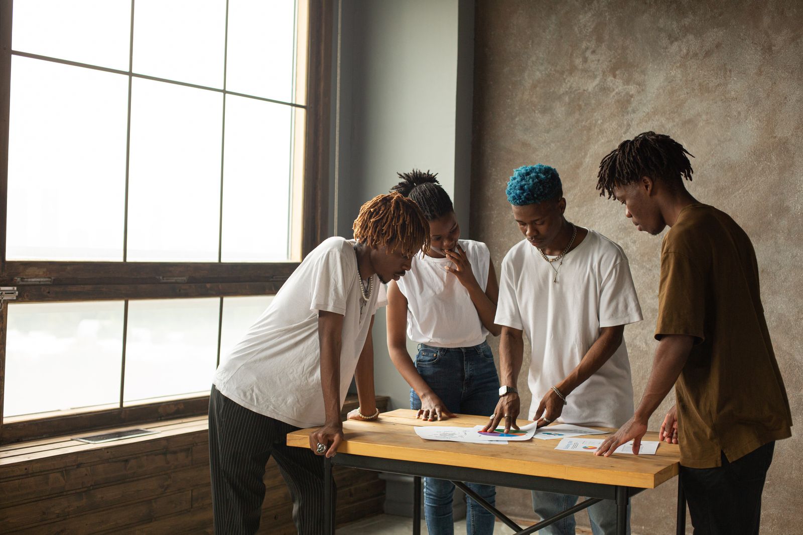 Creative collaborators exchanging ideas around a project table